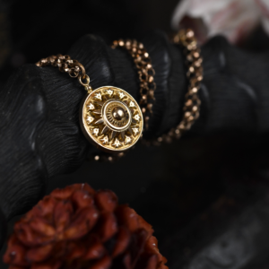 A photograph of a Victorian pendant chain strung over a black buck horn.